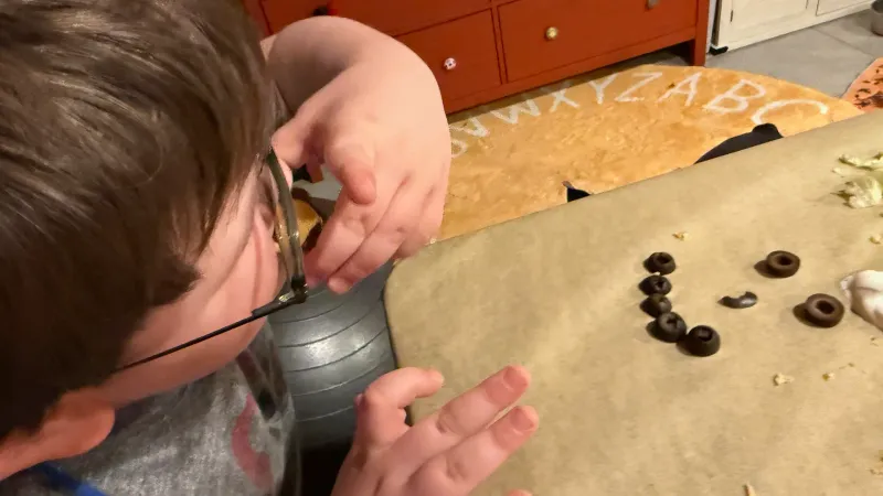 autistic boy trying a new non-preferred food