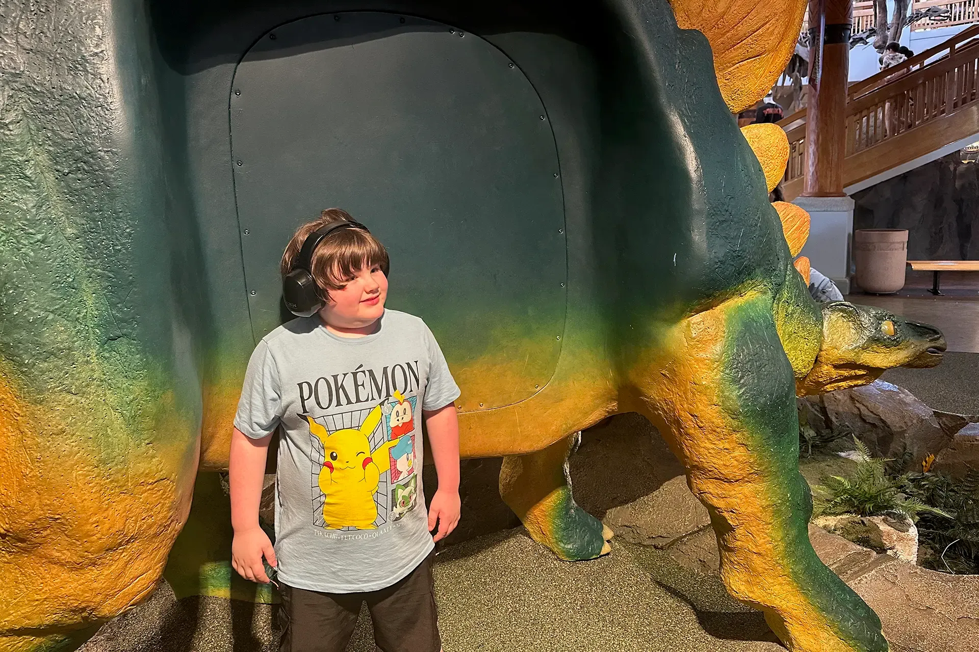 autistic child at dinosaur themed amusement park