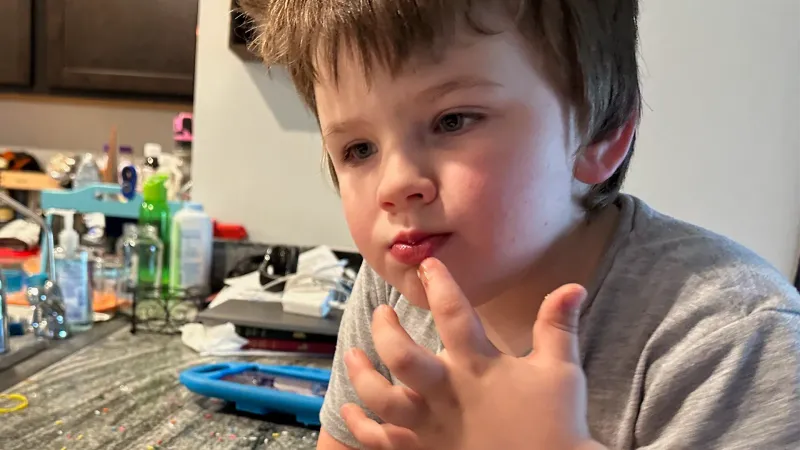 a little boy with autism and ARFID tasting a new food